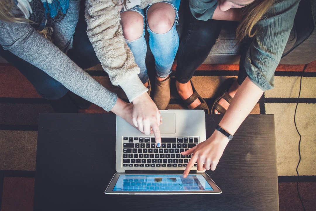 people collaborating on a computer